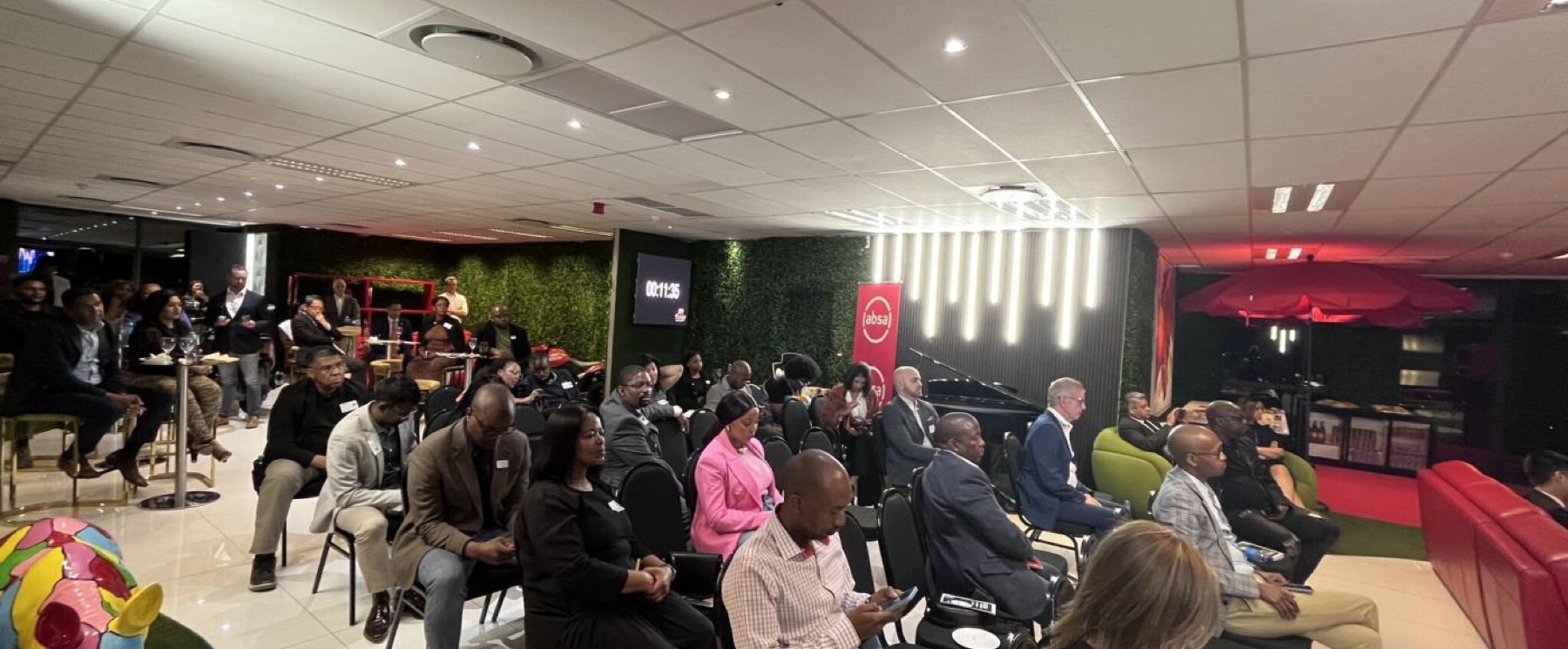 An audience seated for an evening event in a members lounge