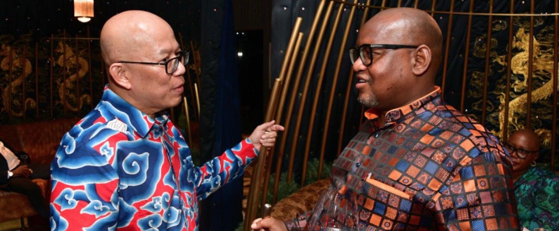 Two members in conversation at an evening reception